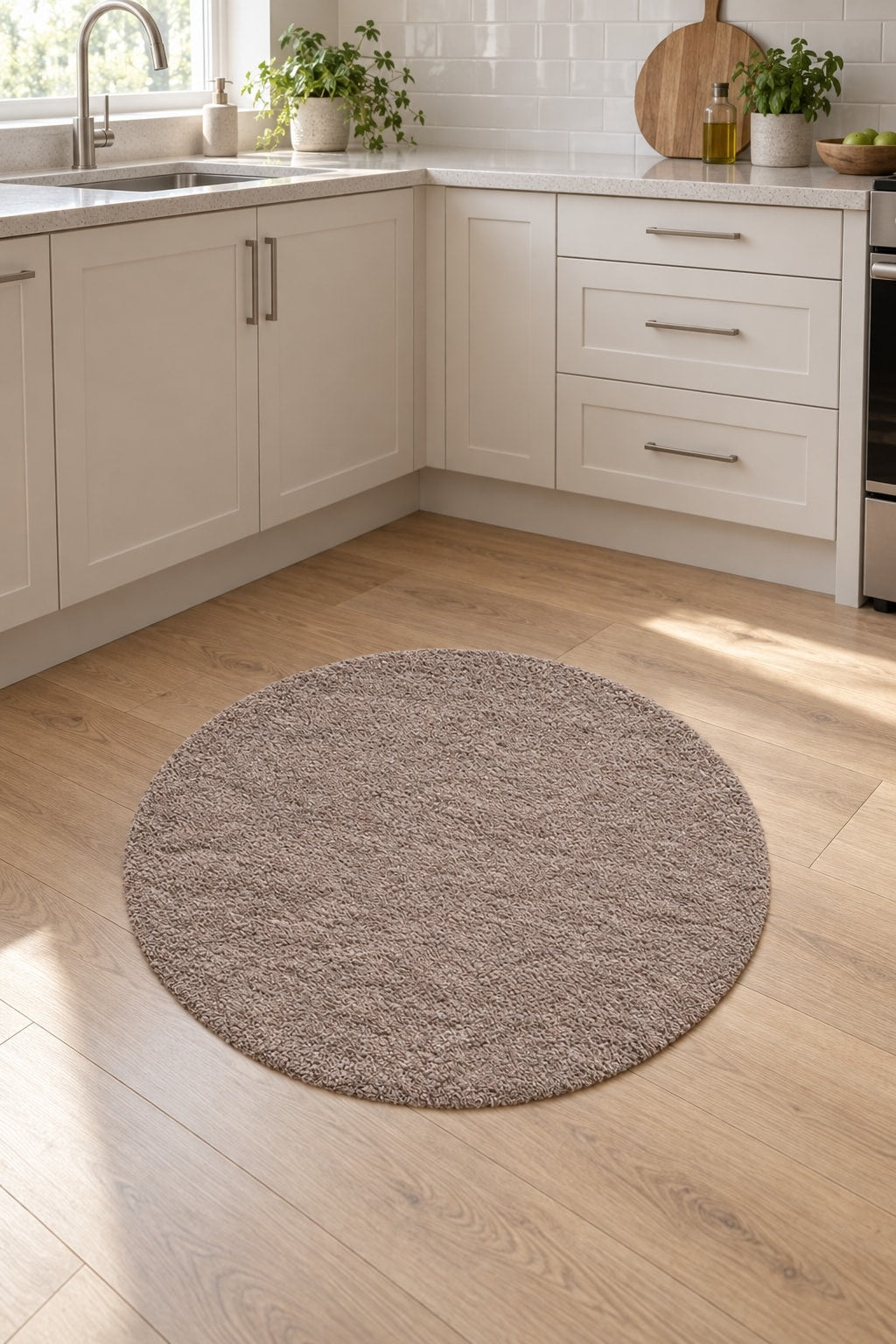Solid Modern Round Plush Rug – Taupe in a kitchen