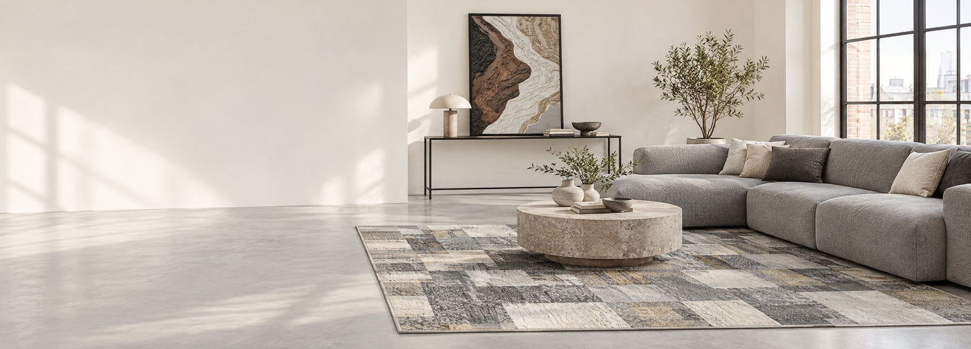 Modern loft living room with a gray patchwork area rug