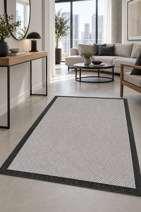 Border Modern Kitchen Rug – Ecru & Black in a hallway