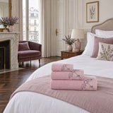 Embroidered Cotton Bath Towel Set of 3 – Pink in a bedroom