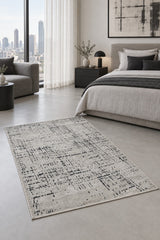 Geometric Boho Area Rug – Taupe in a bedroom