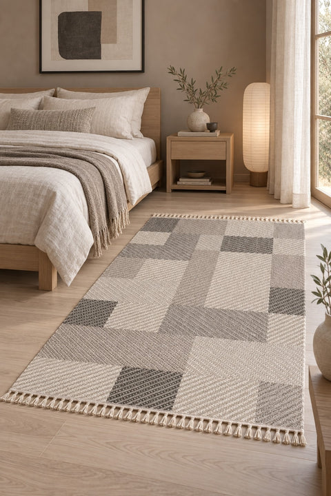 Loop Geometric Area Rug – Taupe & Gray in a bedroom