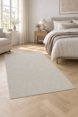 Looped Modern Area Rug – White in a bedroom