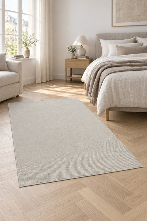 Looped Modern Area Rug – White in a bedroom