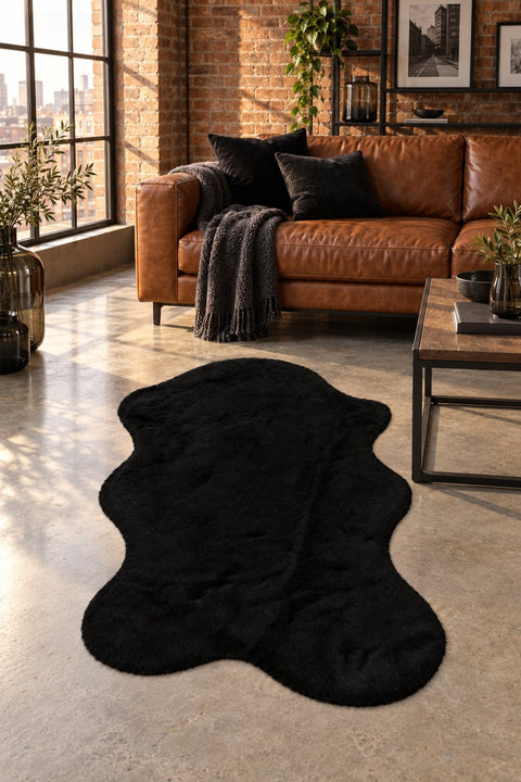 Plush Shag Kids Oval Rug – Black in a living room