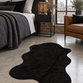 Plush Shag Kids Oval Rug – Black in a bedroom