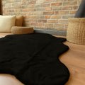 Plush Shag Kids Oval Rug – Black in a living room