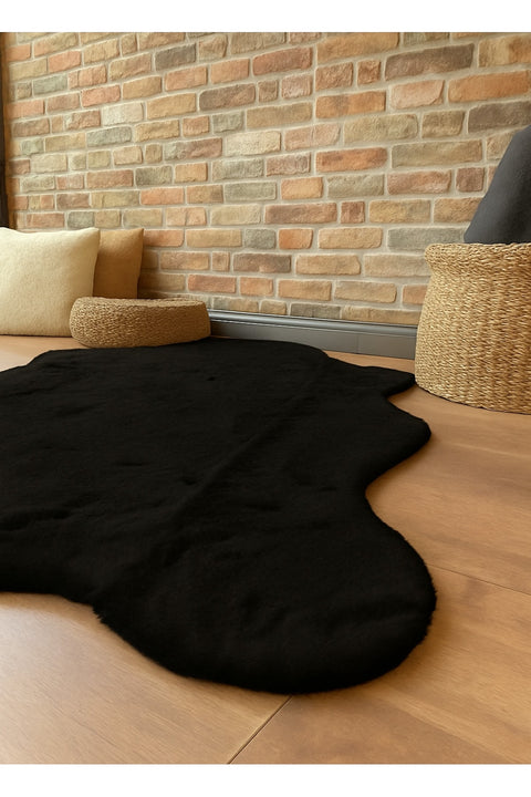 Plush Shag Kids Oval Rug – Black in a living room