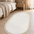 Puffy Geometric Boho Oval Rug – White in a bedroom