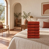 Solid Cotton Hand Towel Set of 6 – Terracotta in a bedroom