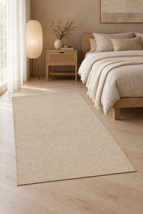 Solid Modern Area Rug – Beige in a bedroom