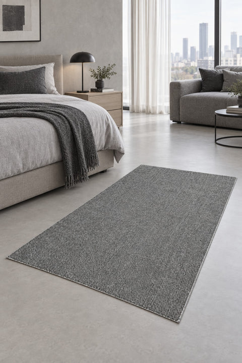 Solid Modern Area Rug – Gray in a bedroom