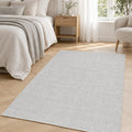 Solid Modern Area Rug – Light Gray in a bedroom