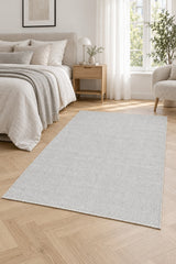 Solid Modern Area Rug – Light Gray in a bedroom