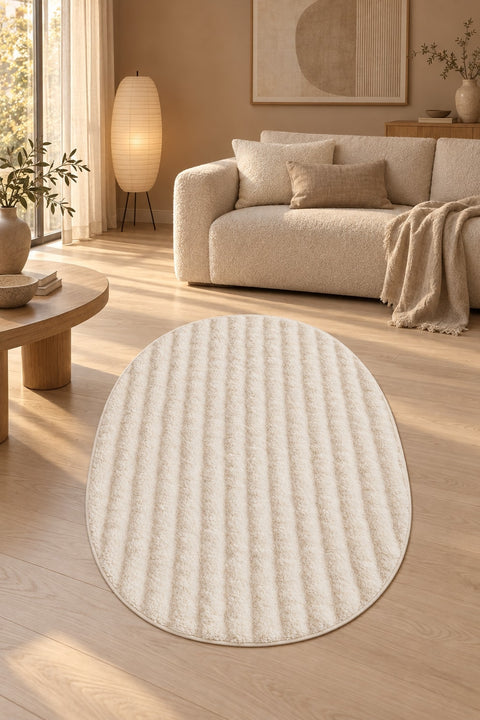 Solid Modern Oval Shag Rug – Cream in a living room