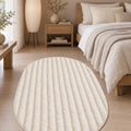 Solid Modern Oval Shag Rug – Cream in a bedroom