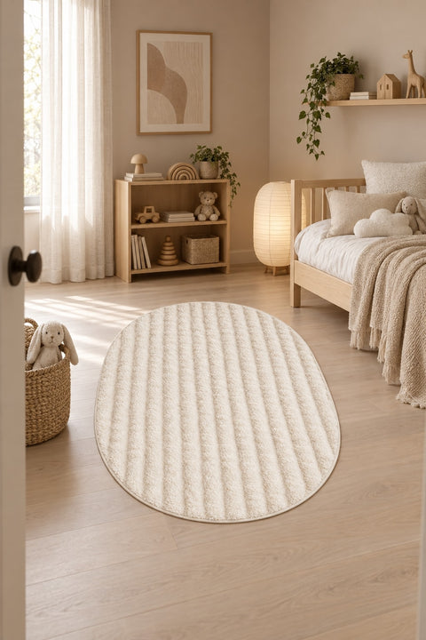 Solid Modern Oval Shag Rug – Cream in a nursery