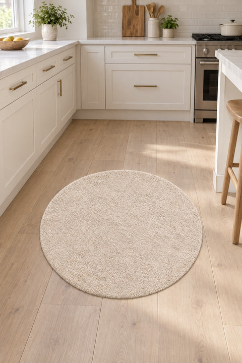 Solid Modern Round Plush Rug – Beige in a kitchen