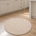 Solid Modern Round Plush Rug – Beige in a kitchen