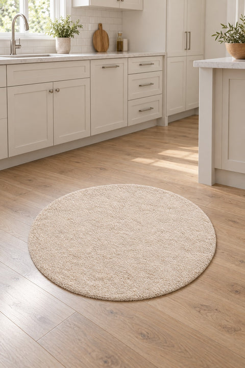 Solid Modern Round Plush Rug – Beige in a kitchen