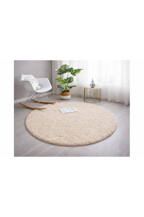 Solid Modern Round Plush Rug – Beige in a living room