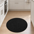 Solid Modern Round Plush Rug – Black in a kitchen
