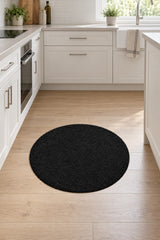 Solid Modern Round Plush Rug – Black in a kitchen