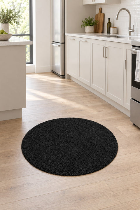 Solid Modern Round Plush Rug – Black in a kitchen