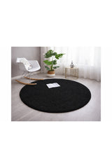Solid Modern Round Plush Rug – Black in a living room