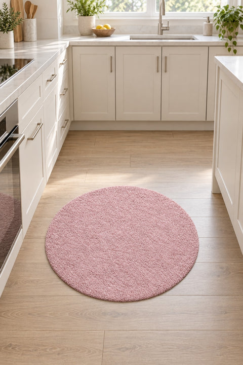 Solid Modern Round Plush Rug – Blush in a kitchen