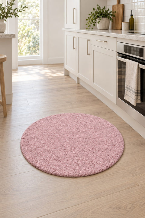 Solid Modern Round Plush Rug – Blush in a kitchen