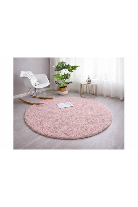 Solid Modern Round Plush Rug – Blush in a living room