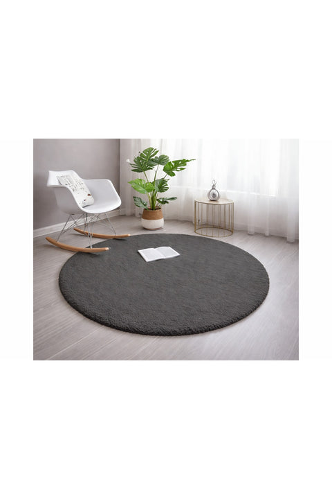 Solid Modern Round Plush Rug – Charcoal in a living room