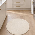 Solid Modern Round Plush Rug – Ecru in a kitchen