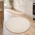 Solid Modern Round Plush Rug – Ecru in a kitchen