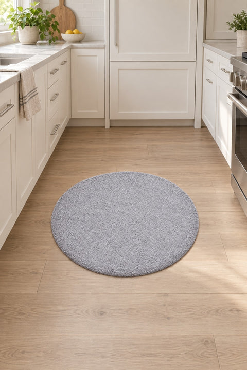 Solid Modern Round Plush Rug – Gray in a kitchen