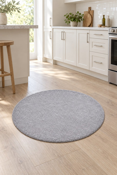 Solid Modern Round Plush Rug – Gray in a kitchen