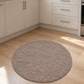 Solid Modern Round Plush Rug – Taupe in a kitchen