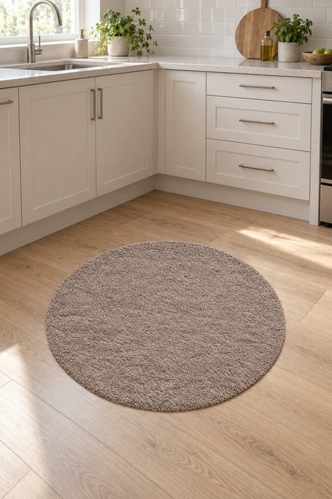 Solid Modern Round Plush Rug – Taupe in a kitchen