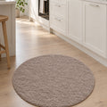Solid Modern Round Plush Rug – Taupe in a kitchen