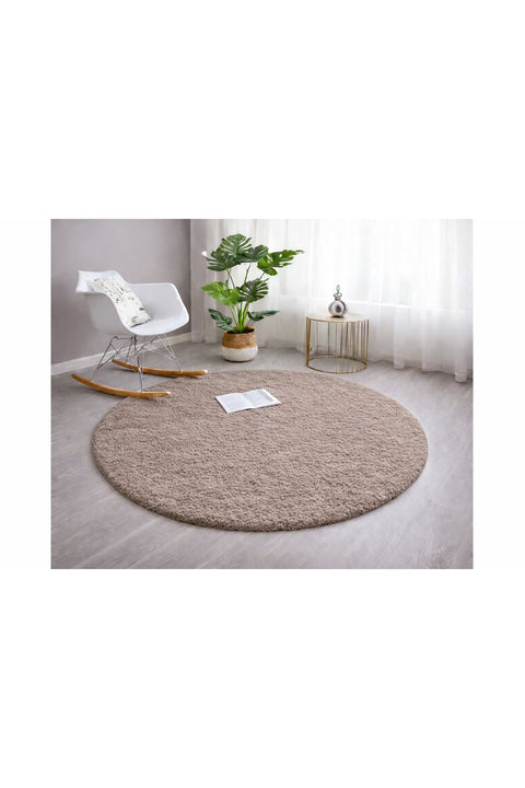 Solid Modern Round Plush Rug – Taupe in a living room