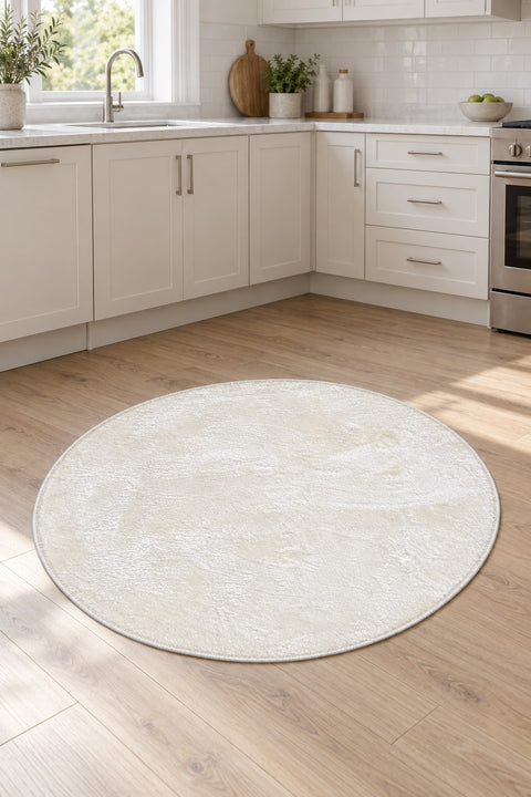 Solid Modern Round Plush Rug – White in a kitchen