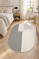 Striped Modern Oval Rug – Gray in a bedroom